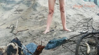 Public peeing teen girl on the beach
