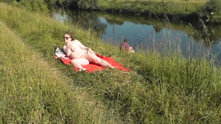 Riverside naked milf sunbathing is not shy about random fisher. Outdoors. Wild beach. Public nudity