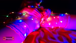 Snow Maiden brings herself to orgasm in Christmas lights