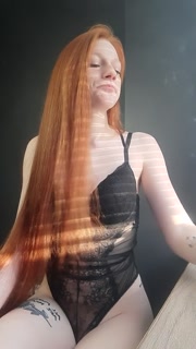 redhead girl sexually smokes a cigarette