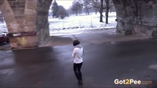 Woman Pissing in a City in Winter